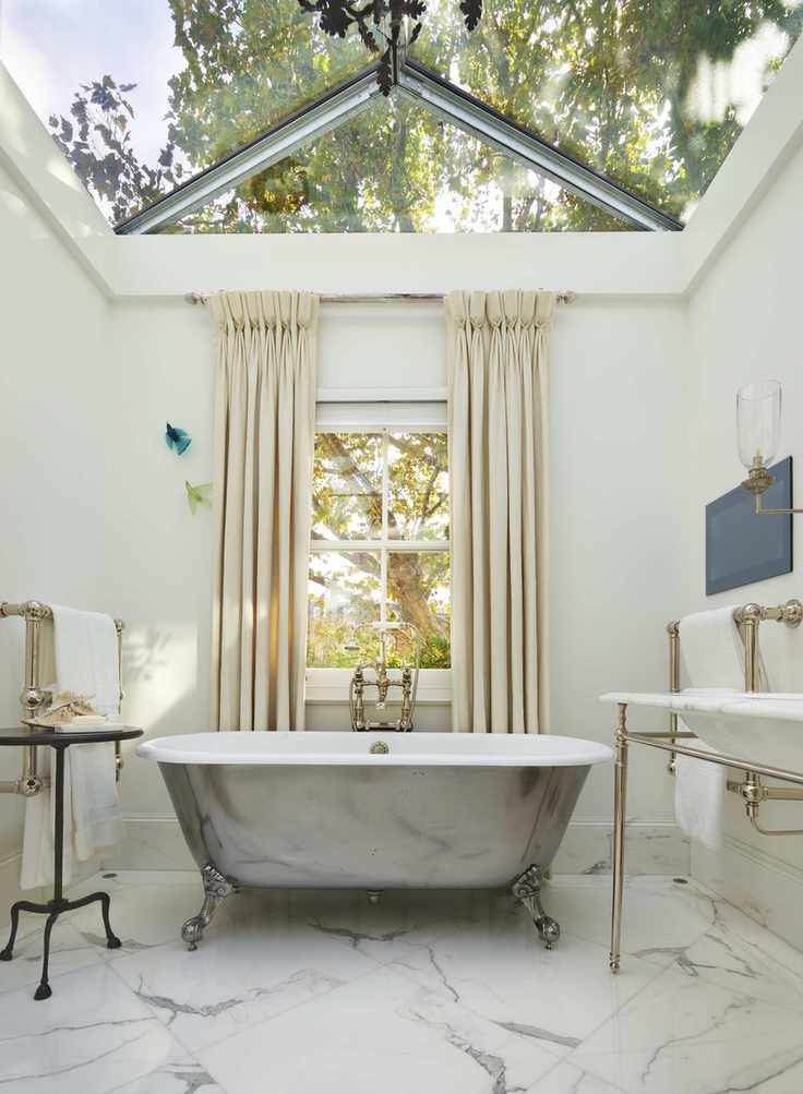 007 drummonds bathroom with skylight and window, marble floor and freestanding metallic bath in center