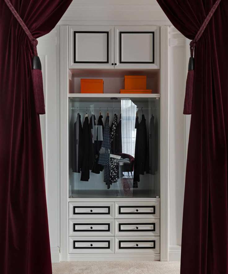 View into walk in wardrobe, framed by elegant, velvet purple drapes