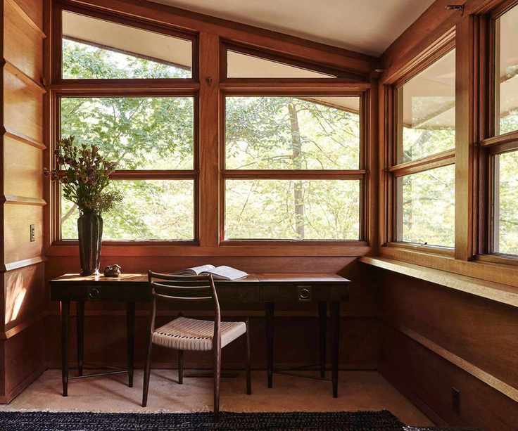 Midcentury office with wood panelling, large windows and wood chair and desk