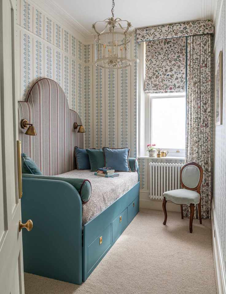 Patterned double-dressed window in a beautifully decorated guest bedroom with a teal trundle bed