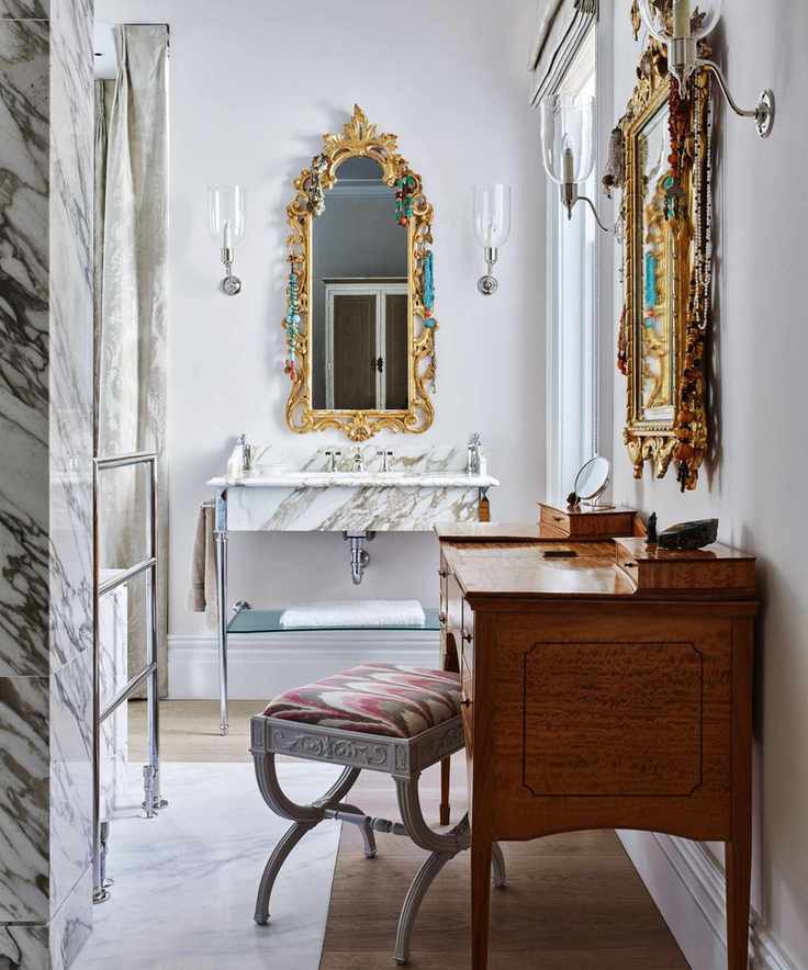 Gold framed mirror, sink, wooden table