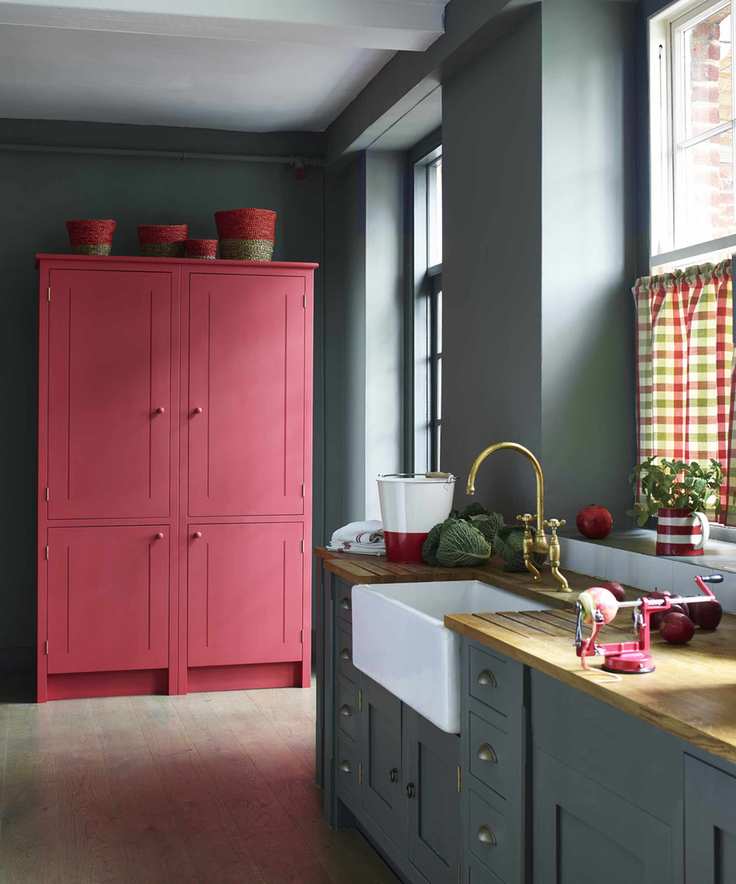 A gray kitchen with a freestanding red cupboard used for freestanding kitchen cupboard storage ideas.