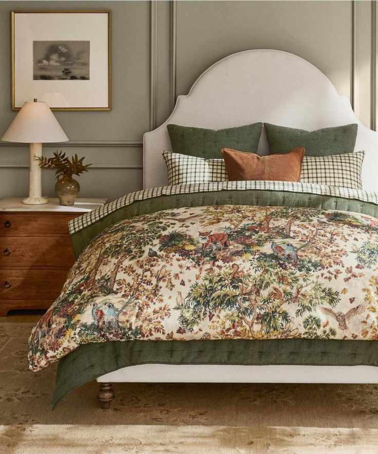 neutral bedroom with grey panelled walls, a sculptural headboard in linen with forest green and plaid bedding