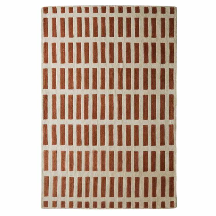 a rug with a repetitive burnt red and cream pattern