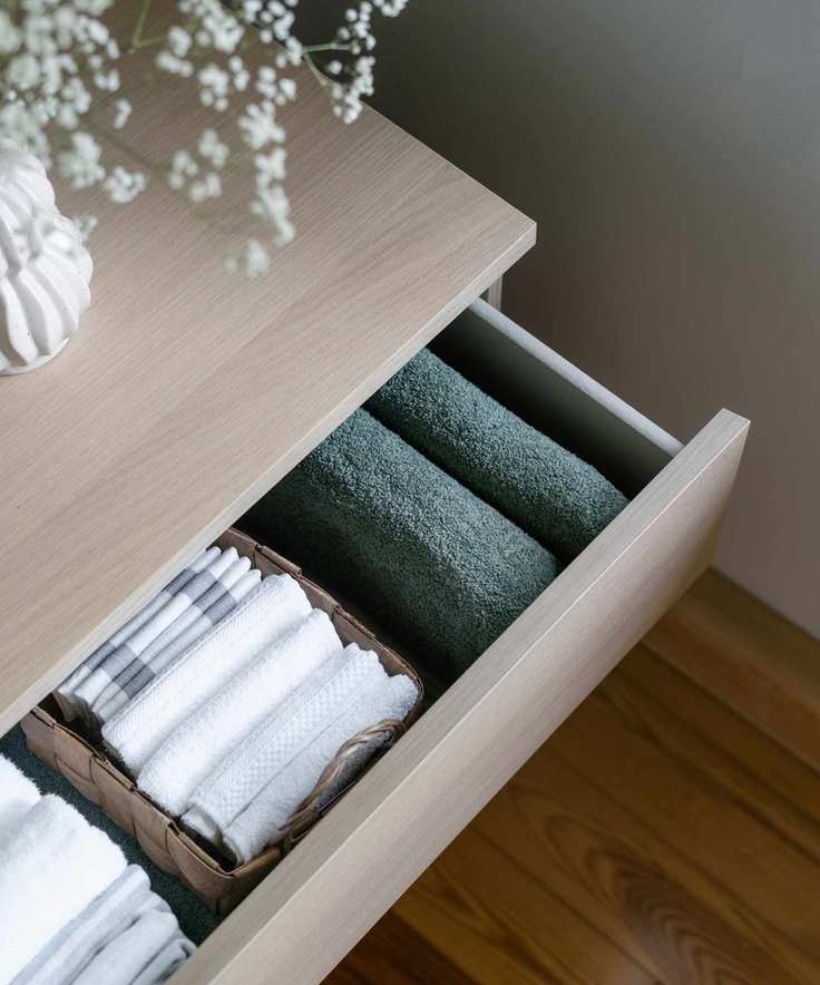 Neatly file folded clothes in a drawer