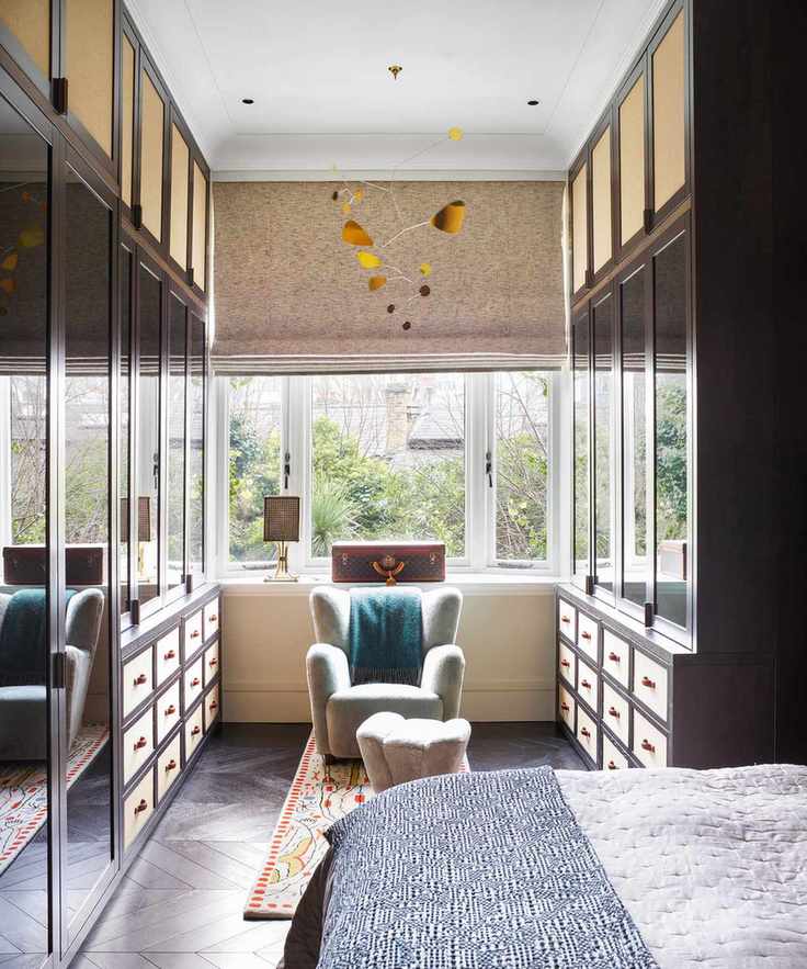 Bespoke bedroom storage featuring a walk-in closet with dual gallery cabinets and drawers.