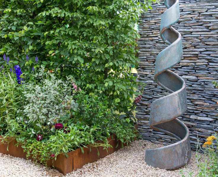 courtyard garden with hedge, corten steel beds and sculpture