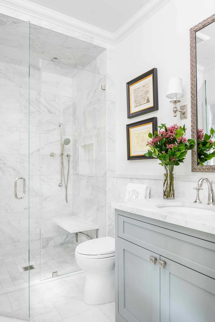Bathroom with gray vanity, toilet and shower with white tile walls