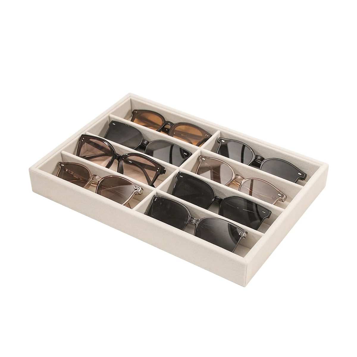 A beige sunglasses organizing tray filled with sunglasses