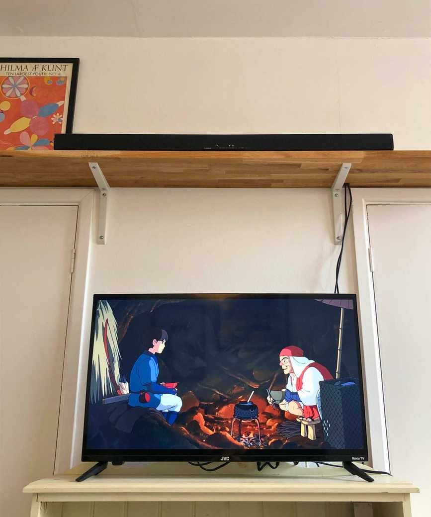 Yamaha True X Bar 40A soundbar on wooden shelf above TV playing Princess Mononoke in Dan Fauzi's home.