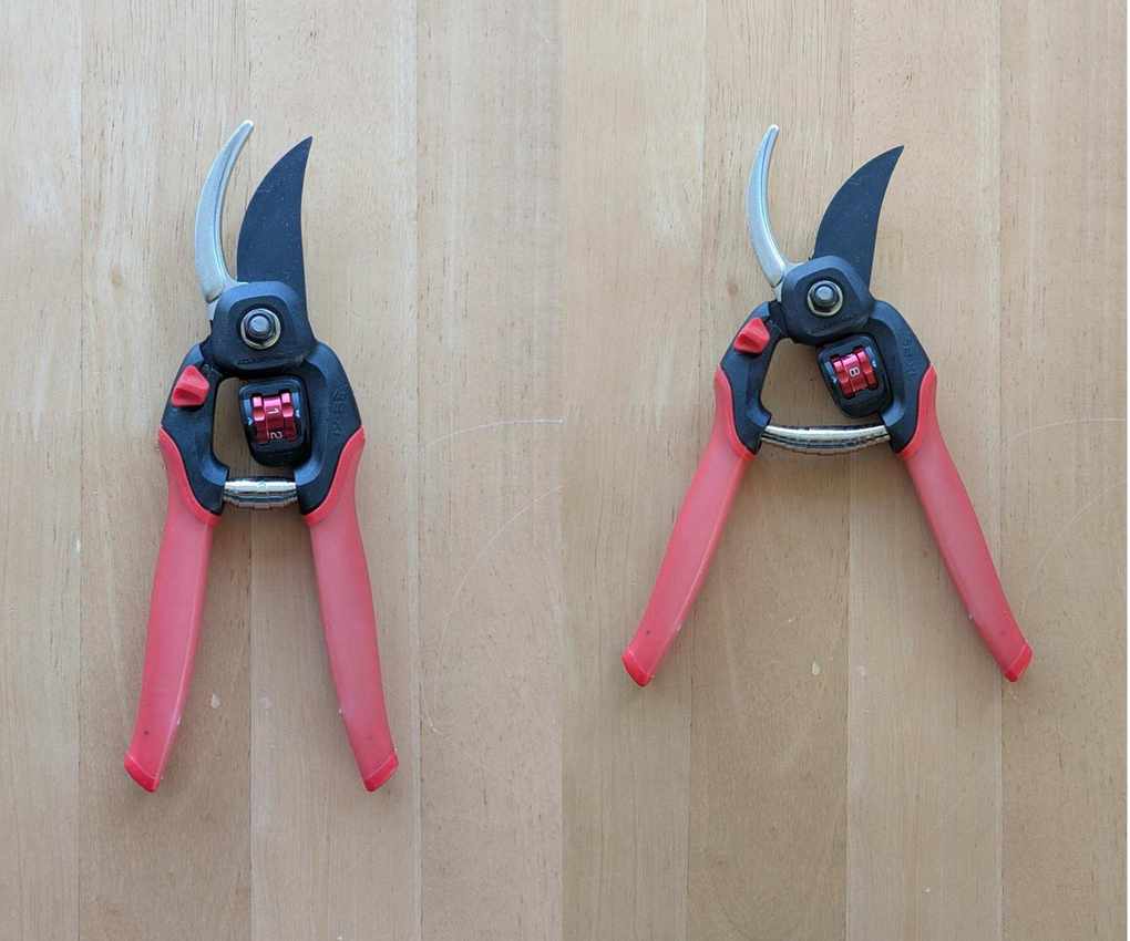 A pair of open Corona FlexDIAL ComfortGEL Bypass Pruner side by side to show the different ranges