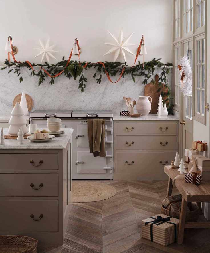 neutral painted kitchen with an island, decorated with rustic Christmas decorations and garlands