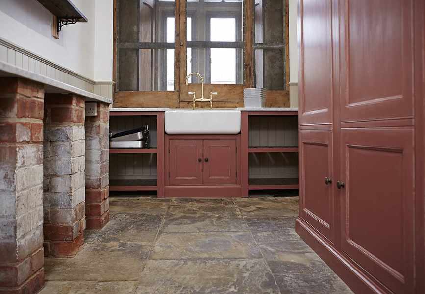Original flooring in a red rustic kitchen