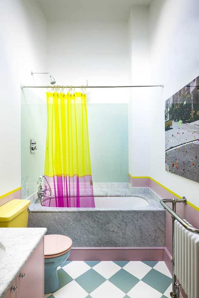 Bathroom with bath and shower over and shower curtain and checkered tile floor