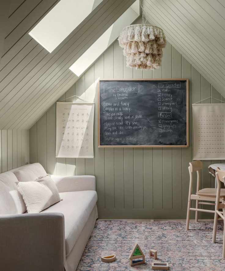 A green playroom with a high ceiling