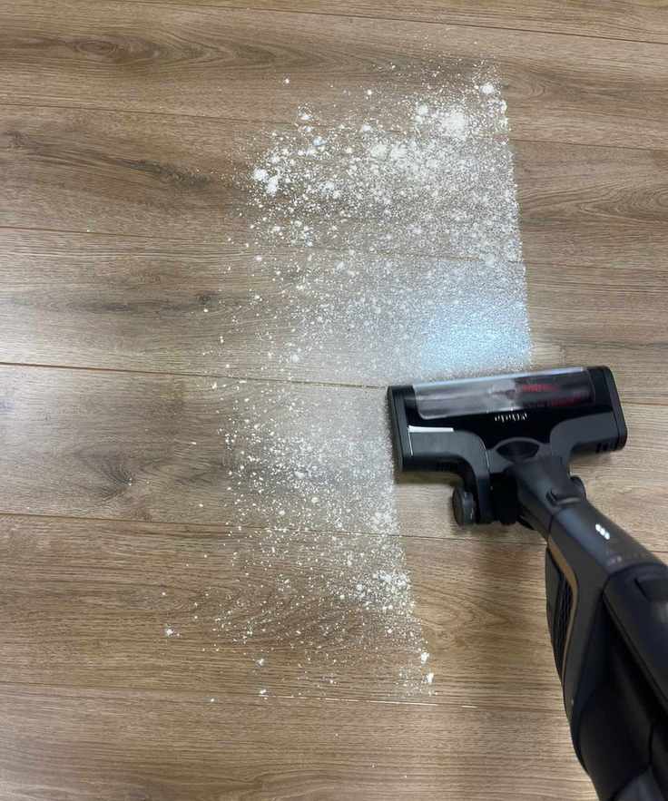 Miele Triflex HX2 Pro vacuuming flour and sugar on wooden floor