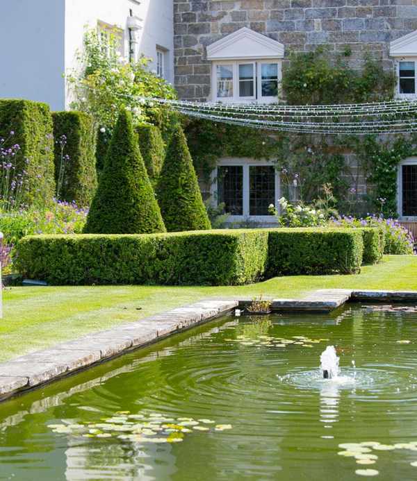 parterre garden by a pond in a garden designed by Jo Thompson