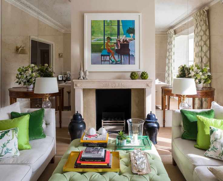 Beige living room with striking green accents and mirrored walls.