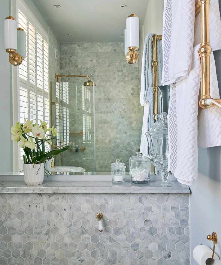 Large mirror enhancing the illusion of space in a shower design for a compact bathroom.