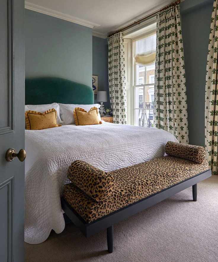 Bedroom decorated with an animal print ottoman