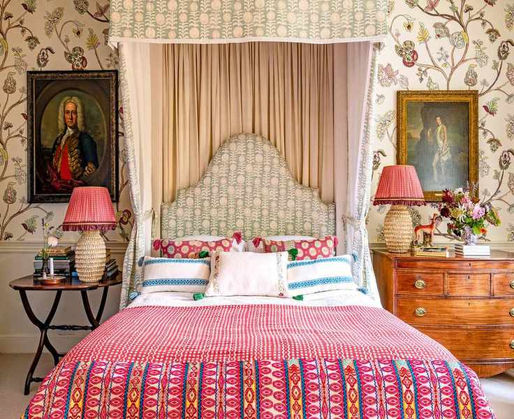 Bedroom with patterned fabrics and wallpaper