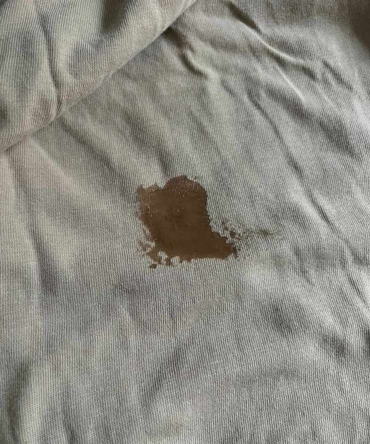 A wet patch over some old blood stains on a beige top