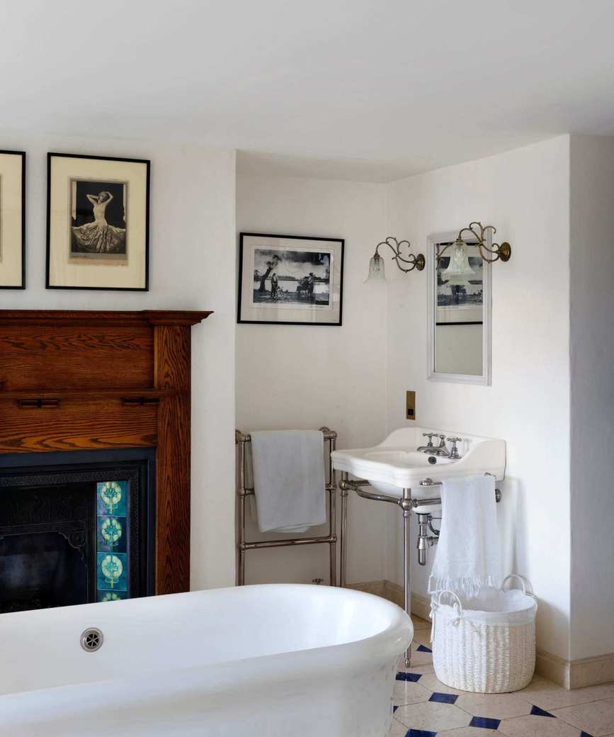 modern bathroom with old wood antique fireplace
