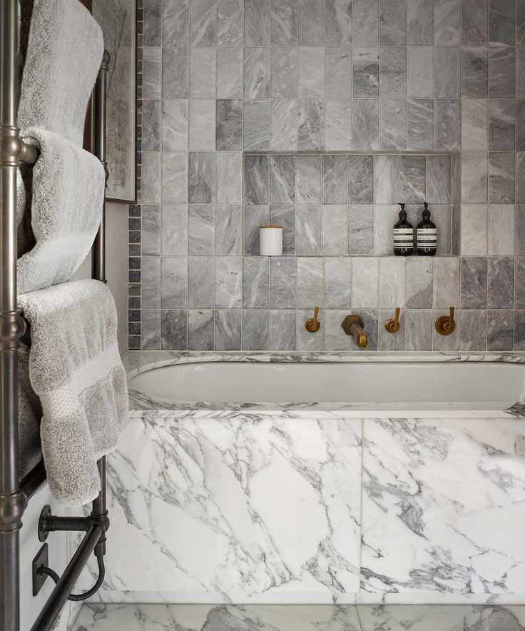 Bathroom with gray marble tiles and a towel rail