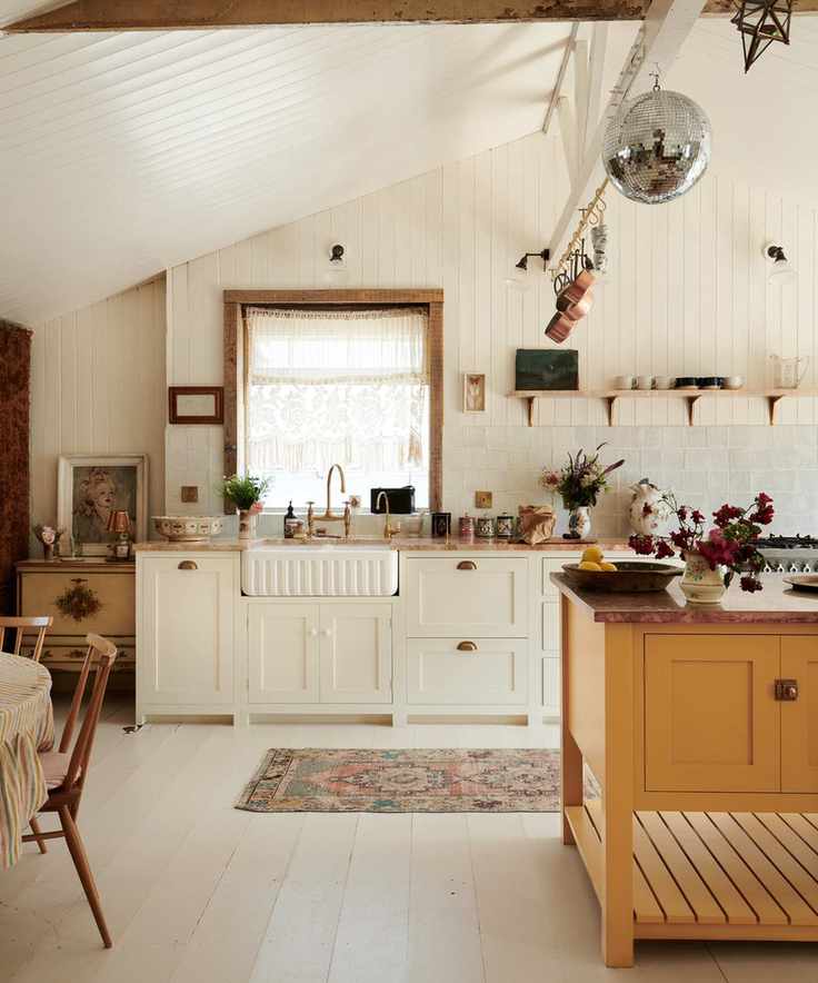 how to design a home that feels like you, vintage style kitchen with shiplap walls, vintage pieces, fringed pendant light, fluted sink, brass faucet, mustard island, dining table, open shelving