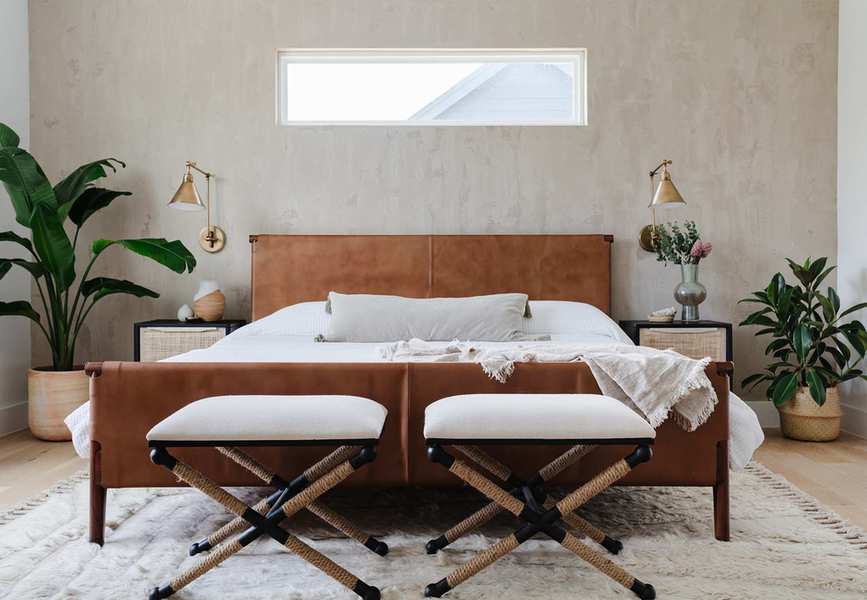 Bedroom with plaster walls, leather headboard and house plants