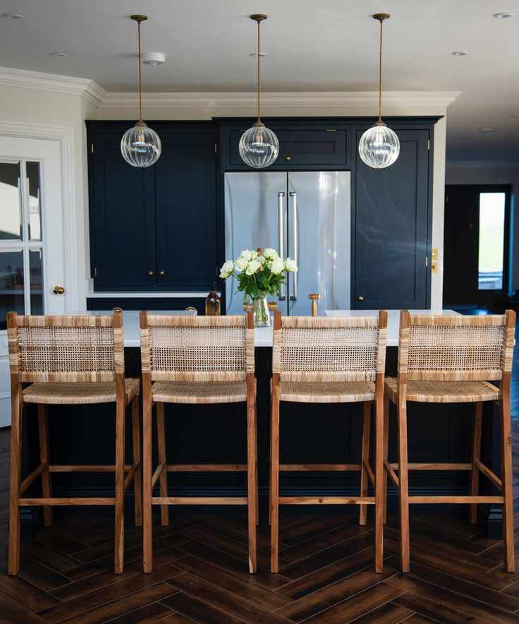 navy and white kitchen with integrated refrigerator, glass pendant lights