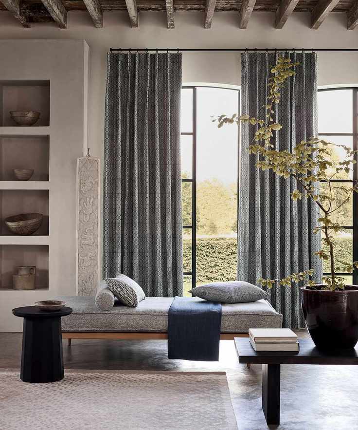 Contemporary living room with rustic wooden ceiling, long gray curtains over window
