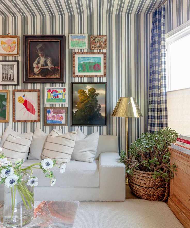 stripe drenched living room with white and blue striped wallpaper on the walls and ceiling, a white couch, gallery wall and a chrome floor lamp