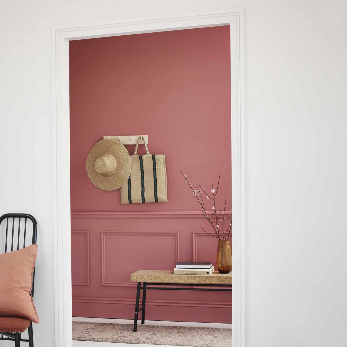 pink entryway with painted panelling, bench, shaker peg rail with hat/basket