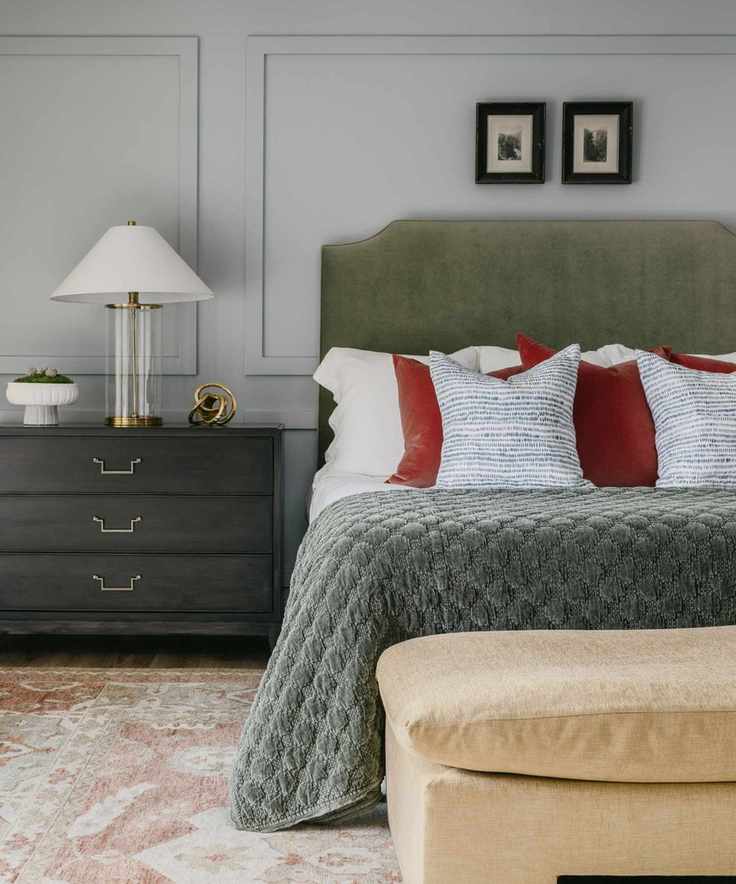 tama bell design primary bedroom with soft blue walls, and green and red accents