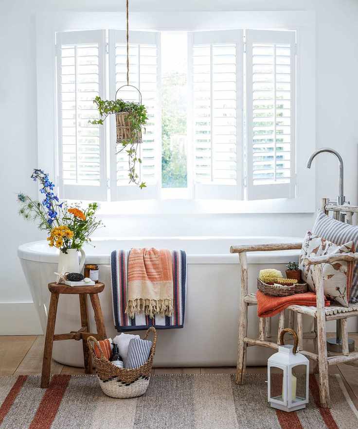 A country-style white bathroom with wooden accents