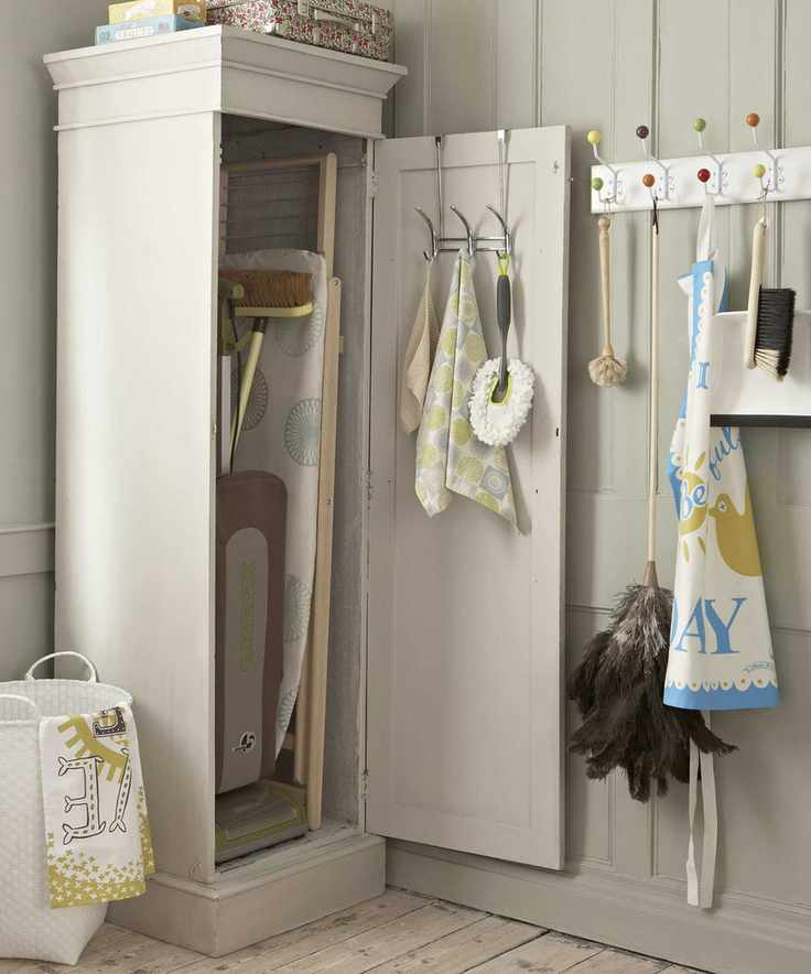 Laundry room showcasing a tall cabinet designed for an ironing board.