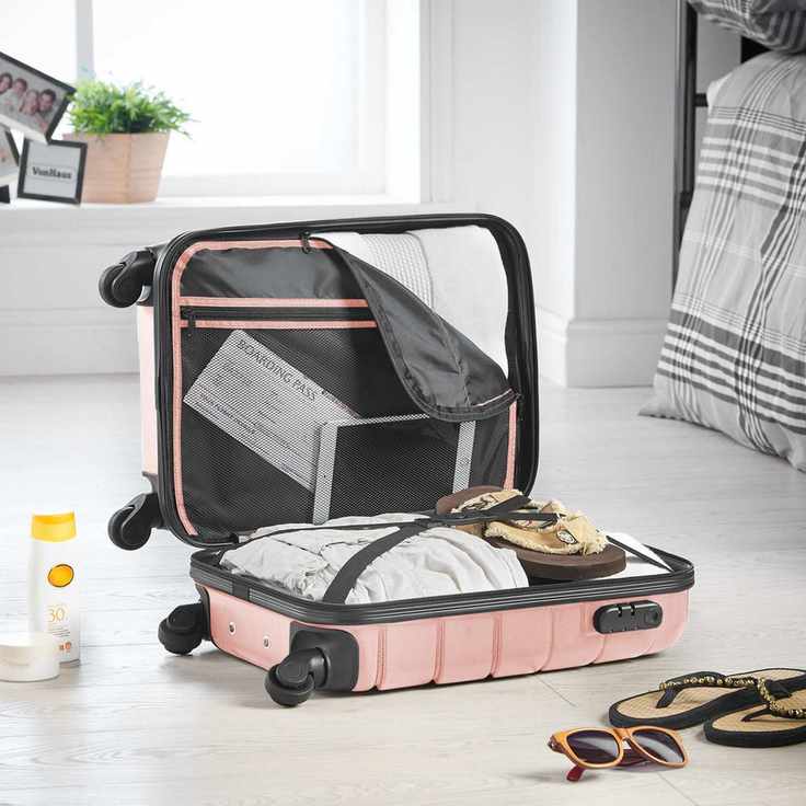 An open, pink luggage case with its contents on display