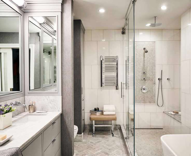Large modern bathroom with gray herringbone floor tiles and walk-in shower