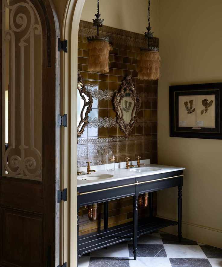 A spacious powder room featuring a washstand vanity and black and white checkerboard tiles