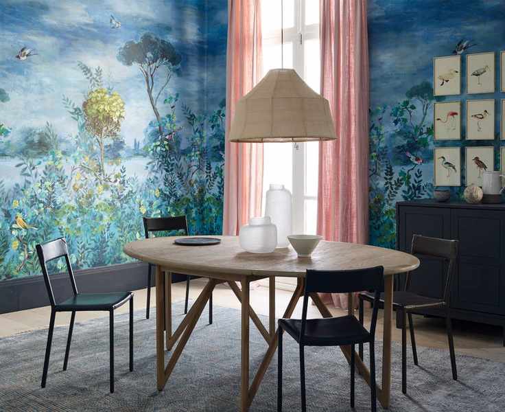 Dining room with a striking blue botanical mural and modern furniture