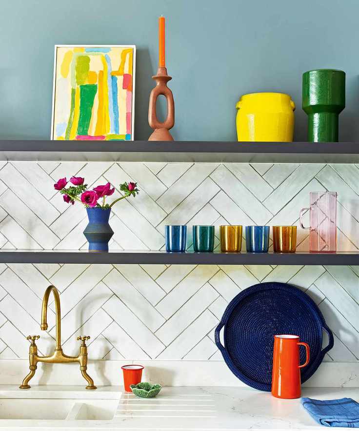 Vibrant kitchen featuring blue walls and decorated shelves