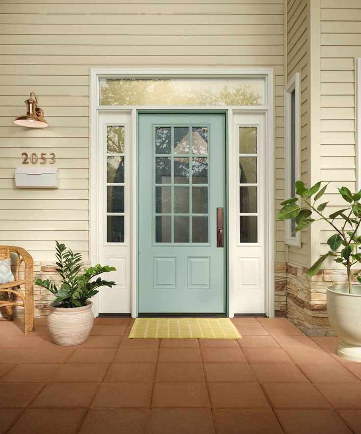 home exterior with neutral walls and teal blue front door