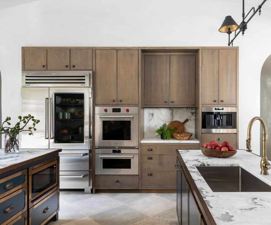 Country style kitchen with white countertops decorated with wooden cutting boards