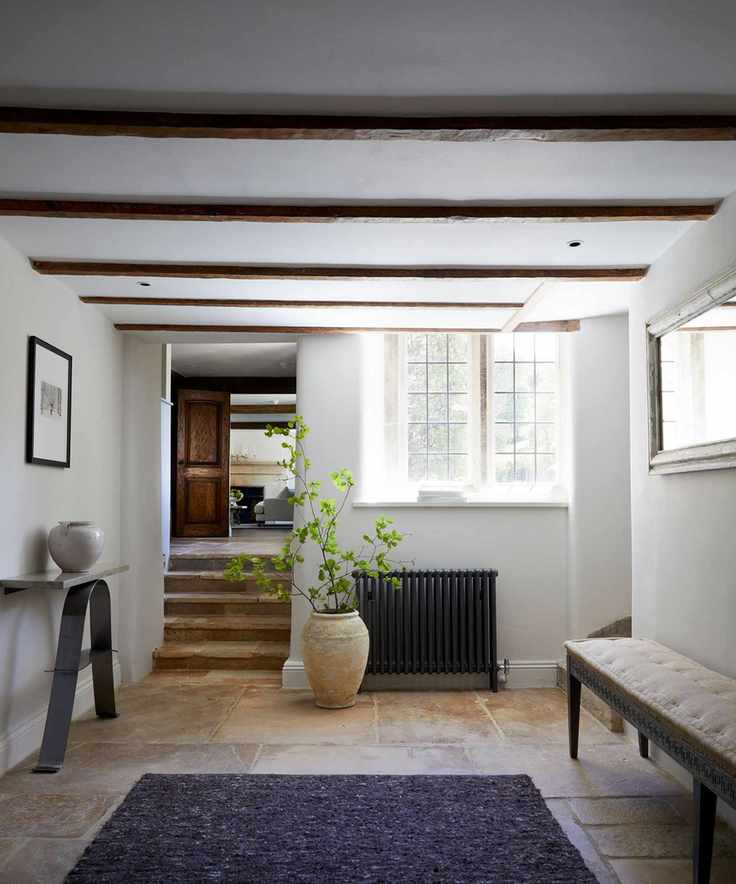 white entryway with bench, radiator and window