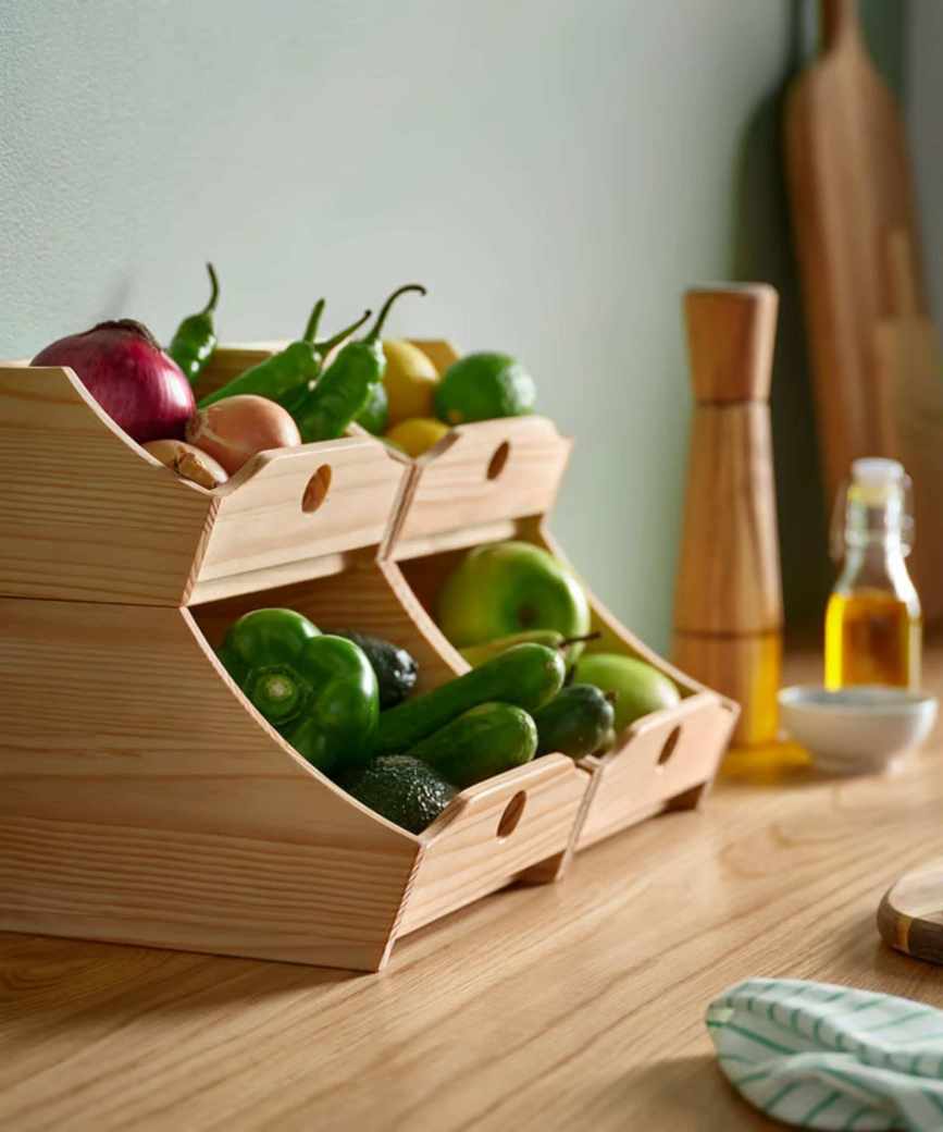 Two sets of IKEA's stacking food boxes in the kitchen, placed side by side on a counter, and packed with vegetables