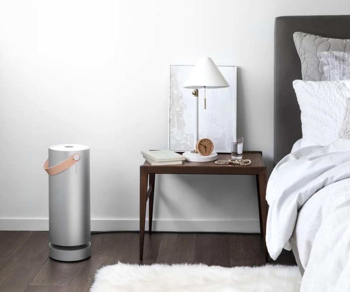 Molekule Air Pro Air Purifier against a bedroom wall.