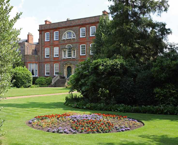 Victorian circular garden bed in lawn full of bedding plants at Peckover House National Trust