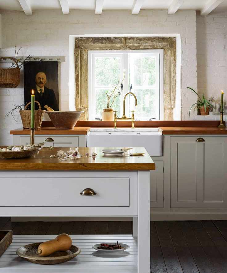 cozy kitchen with wooden countertop and stone walls