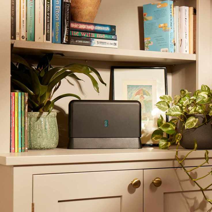 A wifi router on a bookcase